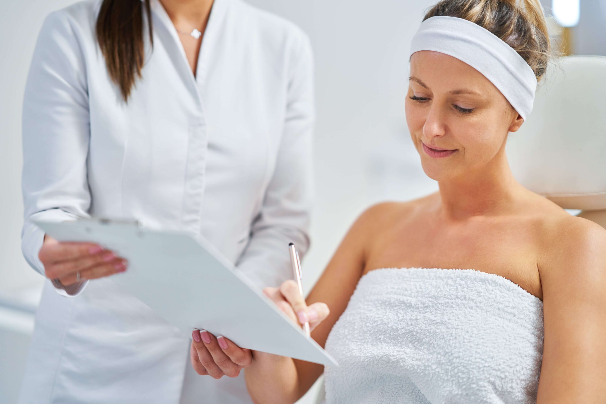 Beautician applying skin care mask in medspa